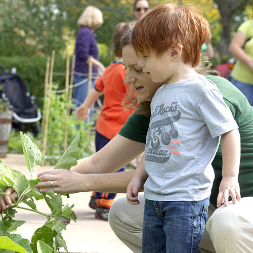 Boy with instructor in Children's Garden